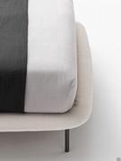 Soft upholstered bed frame coordinates with the headboard