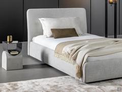 Single bed Tonight by Bonaldo in the version with a high, upholstered bed frame, with the footboard echoing the shape of the headboard 