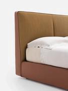 Detail of the two-tone headboard of the Laika bed with cushions in fabric and a leather headboard to match the bed frame. It can also be made entirely of either of these two materials, changing the colour only