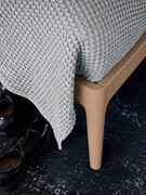 Detail of the foot and graft on the bed frame - matte lacquer finish