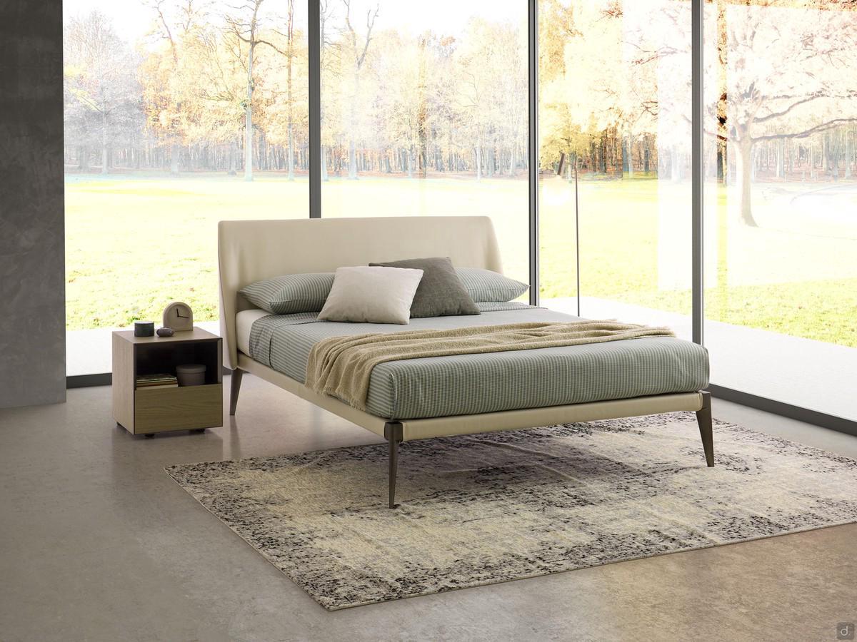 Nobel upholstered bed with leather upholstery that leaves the high metal feet visible