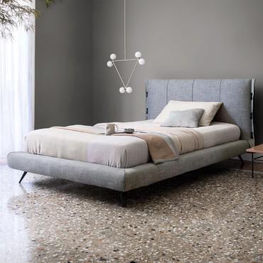 Full-size bed with stitching on the headboard Cuff by Bonaldo