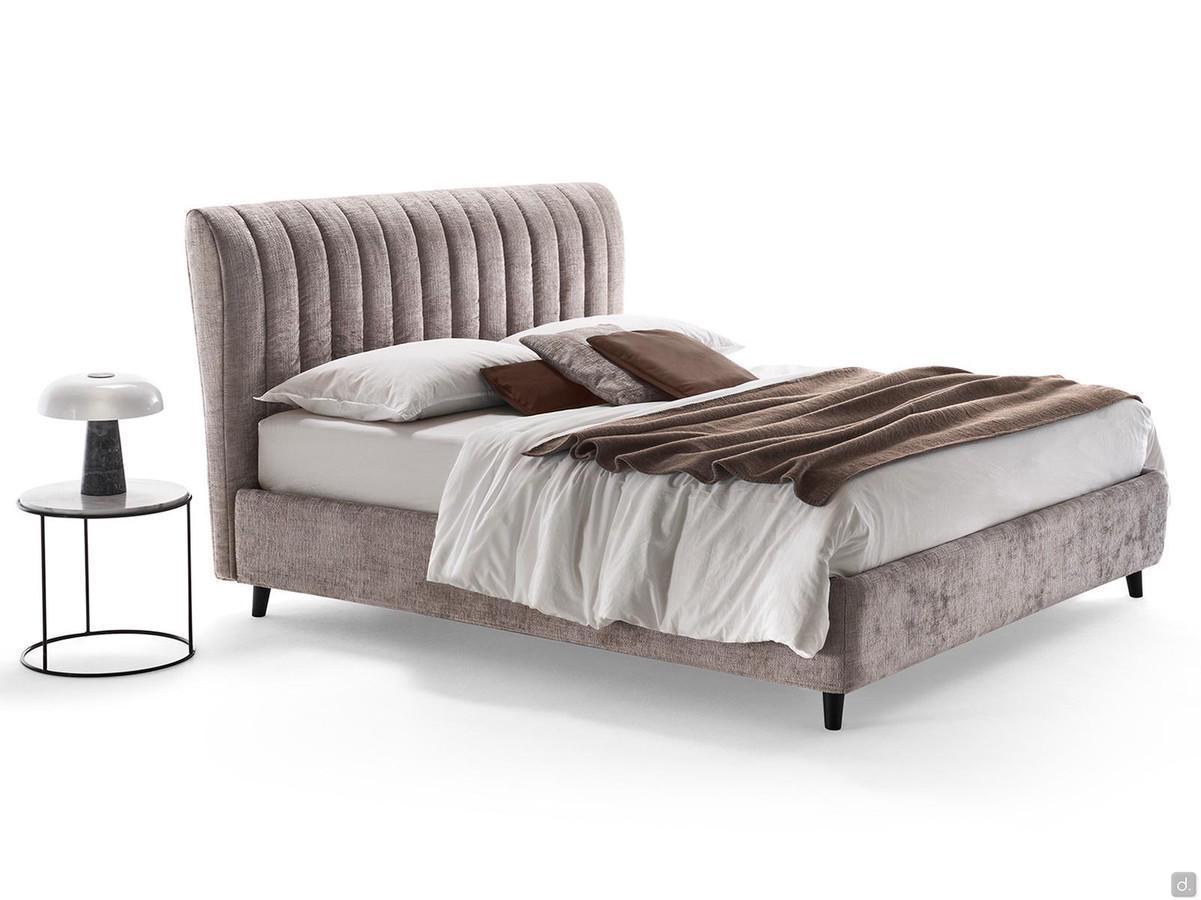 Joao shaped high headboard bed with vertical striped quilting that enhances the tall, slender effect