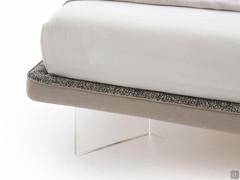 Detail of the only 5 cm high bed frame upholstered with two different fabrics in a two-tone version