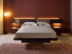 Planeur bed with symmetrical headboard with two side panels. Upper and lower LED lighting on panels and headboard, and lower on bed frame