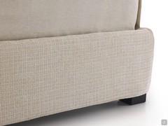 Detail of the 30 cm high upholstered bed frame with square wooden feet