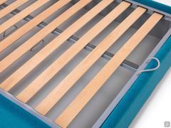 Detail of the wooden slatted bed base with metal frame, equipped with a convenient rope handle for opening the storage box