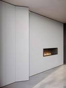 Lounge linear wall cabinet juxtaposed with a module with open compartment and fireplace