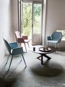 Chairs Cloe with a hexagonal-shaped back slightly bent at the sides and armrests folded outward