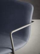 Seat and back detail with matching stitching - metal frame extending laterally to form the armrest