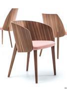 Detail of the Nadine chair in a headboard version with a wood back with a wrap-around shape