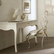 Ghirigori chair with sabre-shaped legs under a white desk