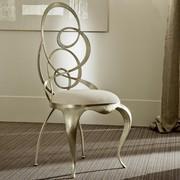 Ghirigori chair with sabre-shaped legs and metal swirls seat-back