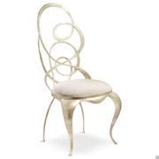 Ghirigori chair with sabre-shaped legs and metal swirls seat-back