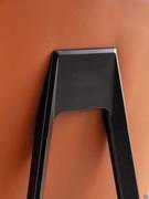 Close up of the die-cast aluminium backrest joint, painted matte black like the legs