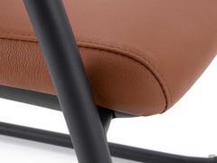 Detail of upholstered seat covered in leather