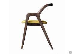 Nakama chair is crafted so that legs, armrests and backrest look like coming from the same piece of wood