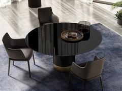 View from above of the Michele upholstered dining chair with armrests, paired with the Hidalgo table. Leather upholstery and solid ash-wood legs in a Black finish.