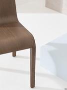 Close-up of the curvature of the light weight oak wood chair with 4 legs Leaf