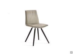 Dalila padded chair with cushion and without armrests. Leather upholstery and wooden trestle legs in the Black-painted finish.