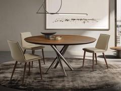 Dalila padded chair with cushion and without armrests. Paired with the Masami table. Leather upholstery and solid ash-wood legs in the Canaletto Walnut finish.