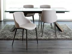 Side and rear view of the Count chair with Joint fabric upholstery and corten painted metal legs