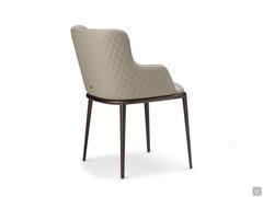 View of the back of the Magda chair with quilted back and legs in embossed metal