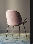 Athena upholstered chair with thin metal legs and armrests which widen outwards