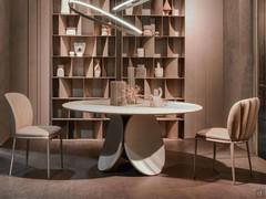 Shell-finish upholstered chair Chrishell by Cattelan paired with Nautilus bookcase