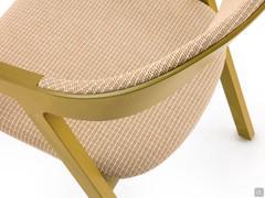 Detail of the curvature of the backrest with a wooden back section and a padded, upholstered inner section