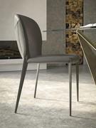 Upholstered chair with steel legs and no armrests Nancy by Cattelan, paired with the Skorpio table