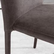 Detail of the seat of the chair Royale upholstered in dove grey vintage faux leather