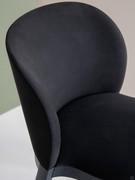 Detail of the wrap-around backrest and solid wood frame skilfully crafted to follow its curved contours