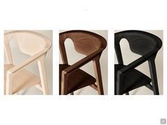 Ashina chair with covered seat in the available finishes. From left to right: natural ash wood, brown ash wood, black ash wood.