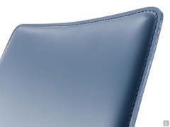 Detail of upholstered backrest covered in leather with visible stitching