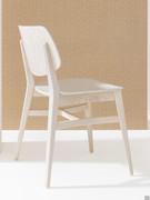 Chloe designer chair with wooden legs and a curved backrest and seat for increased comfort