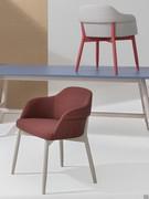 Sophos modern chair upholstered in fabric, characterised by soft, welcoming lines