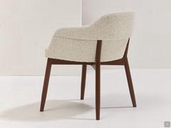 Modern chair upholstered in creamy white bouclè fabric