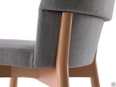 Sophos fabric-covered modern chair with solid wooden frame that also holds the backrest