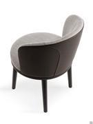 Piper two-tone armchair with wooden legs and a backrest embellished with special stitching that accentuates its shape