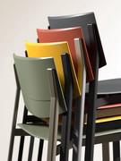 Detail of Omnia chairs in coloured polypropylene, stackable for easy storage and use only in the presence of guests