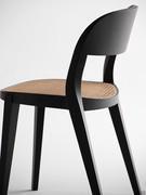 Detail of the sinuous lines of the chair given by the tilting and twisting of the rear legs that become the ntural continuation of the curved backrest in a single continuous profile