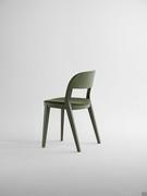 Back view of Minima chair with wooden frame and upholstered seat covered in fabric