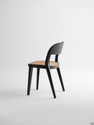 Side view showing the harmonious proportions and sinuous lines of the Minima chair