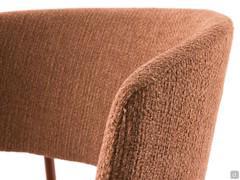 Detail of the upholstered curved backrest with a hint of armrests