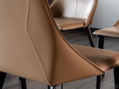 Detail of the shaped backrest with two side wings that join the seat