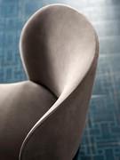 Detail of the low, wide backrest, generously padded and rounded to accommodate the wide, comfortable seat