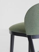 Detail of the sloping wooden back legs perfectly matched to the profile of the curved upholstered backrest