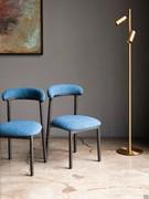 Lisa chairs here with a wenge-stained ash frame combined with a light blue bouclé fabric