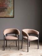 Elegant Lisa armchairs with solid wood frame and curved, welcoming backrest